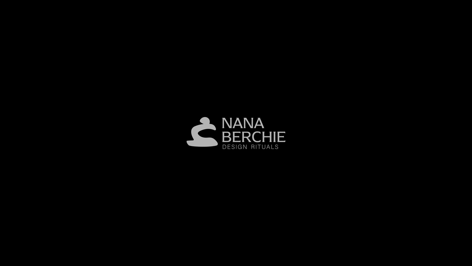Nana Berchie speaking in her studio, shelves of sculptural ceramics behind her